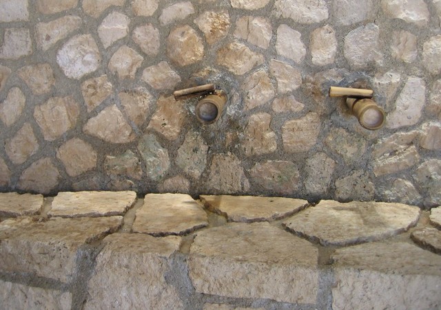 An unusual bathroom sink. The water just runs through the channels between the rocks.