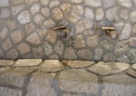 An unusual bathroom sink. The water just runs through the channels between the rocks.